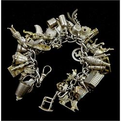 Silver charm bracelet with forty-five silver charms including camera, rolling pin, golf clubs and magnifying glass
