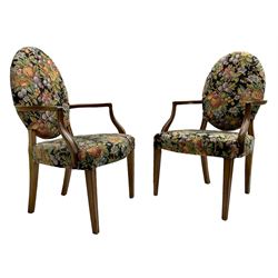 Pair of George III mahogany framed open armchairs, oval back and serpentine seat upholstered in fruit and foliage patterned fabric, shaped and moulded arms and arm supports, on square tapering moulded front supports 