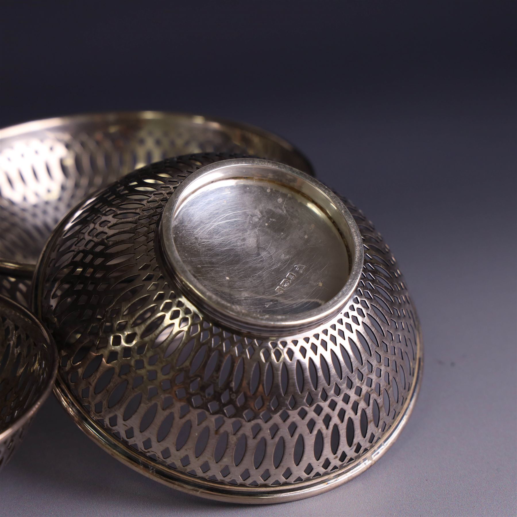 Three 1930s silver bon bon dishes, comprising pair and one larger example, each of circular form with pierced latticework sides, hallmarked Maxfield & Sons Ltd, Sheffield 1936, largest D12cm