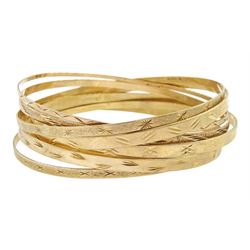 Seven 9ct gold bangles, with engraved decoration, all hallmarked