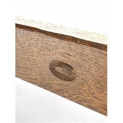 'Acornman' oak bench/occasional table with rectangular adzed top, shaped end supports on sledge feet joined by pegged stretcher carved with acorn signature, by Alan Grainger of Brandsby, York