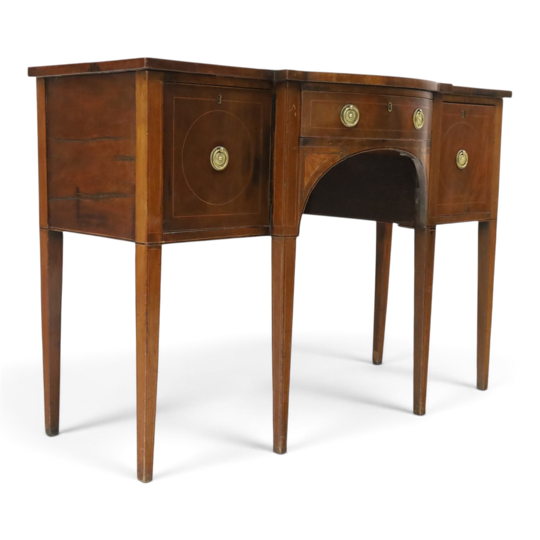 Regency period inlaid mahogany bow-breakfront sideboard, shaped rectangular top with crossbanding and ebony stringing, central convex frieze drawer flanked by cupboard and cellarette drawer, over fan-inlaid spandrels, raised on square tapering supports