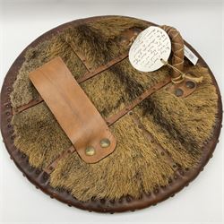 Replica Scottish Highlander's Targe by Joe Lindsay based on a 17th century original which came from Skye, the wooden shield covered in tooled leather with traditional Celtic designs, brass studs and mounts, with deer skin hide verso D49cm