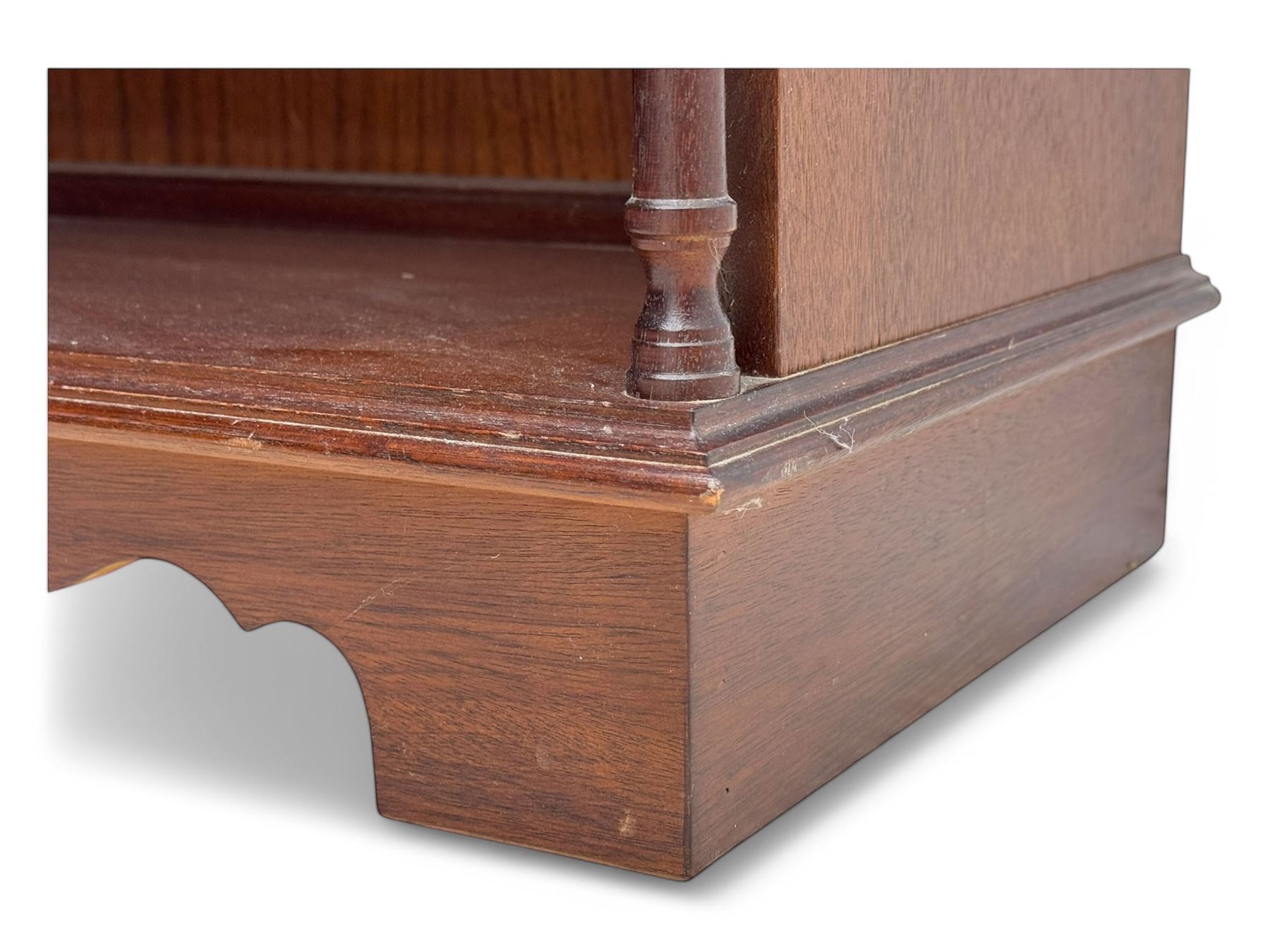 Mid-20th century mahogany open bookshelf, the rectangular top with a brass balustrade gallery, over three shelves each supported by turned column uprights, on shaped apron base