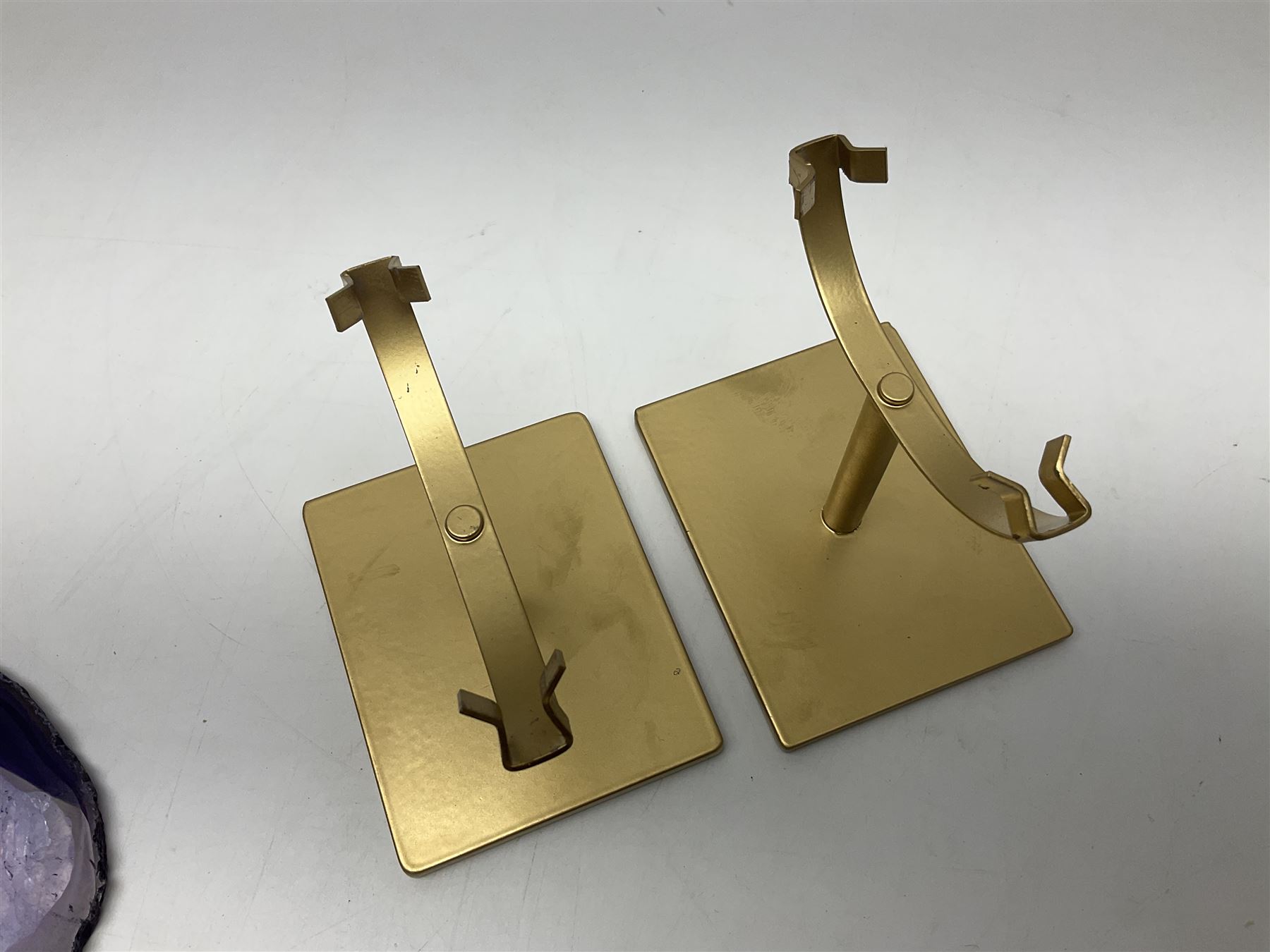 Pair of purple agate slices, polished with rough edges, raised upon gilt metal stands