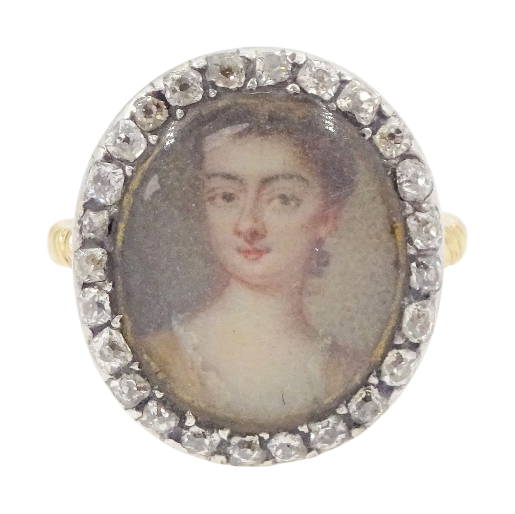 18th/ 19th century gold diamond portrait ring, set with an oval miniature of a woman on ivory, under a glazed panel, with old cut diamond surround and rope twist shank. This lot has been registered for sale under Section 10 of the APHA Ivory Act