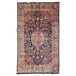 Vintage Persian Tabriz indigo ground rug, the central floral medallion within a field wove...