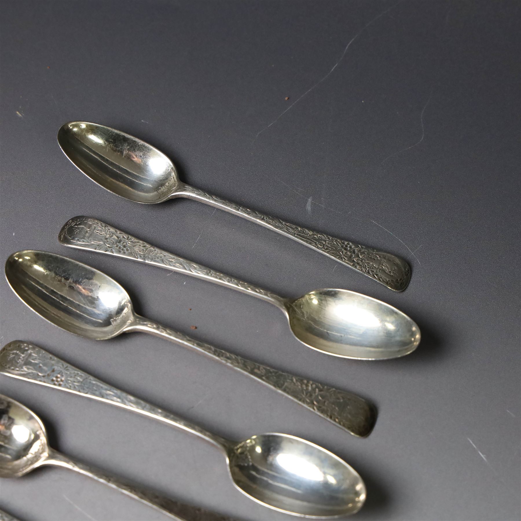 Eleven Victorian silver teaspoons, profusely engraved with floral decoration throughout with family crest to terminal, hallmarked Elkington & Co, Birmingham 1875