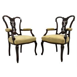 Pair late 19th century mahogany open armchairs, shaped cresting rail over pierced splat carved with flower heads and foliage, serpentine sprung seat, on cabriole front supports