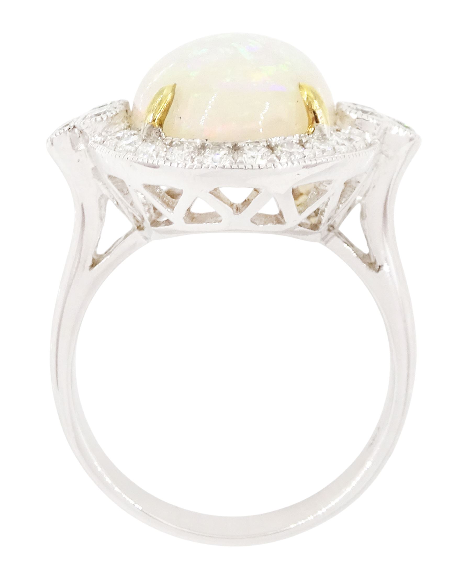 18ct white gold opal and diamond cluster ring, single cabochon cut opal of approx 5.20 carat, surrounded by round brilliant cut diamonds, in a milgrain setting, stamped 750, total diamond weight approx 0.55 carat