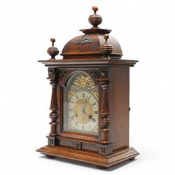 German-Junghans late 19th century oak cased mantle clock, with a domed pediment and three matching turned finials, break arch door beneath with attached turned and tapered pilasters, brass dial with cast spandrels, matted dial centre, steel hands and silvered chapter ring with Roman numerals, two train movement striking the hours and half-hours on a coiled gong. With pendulum and key.