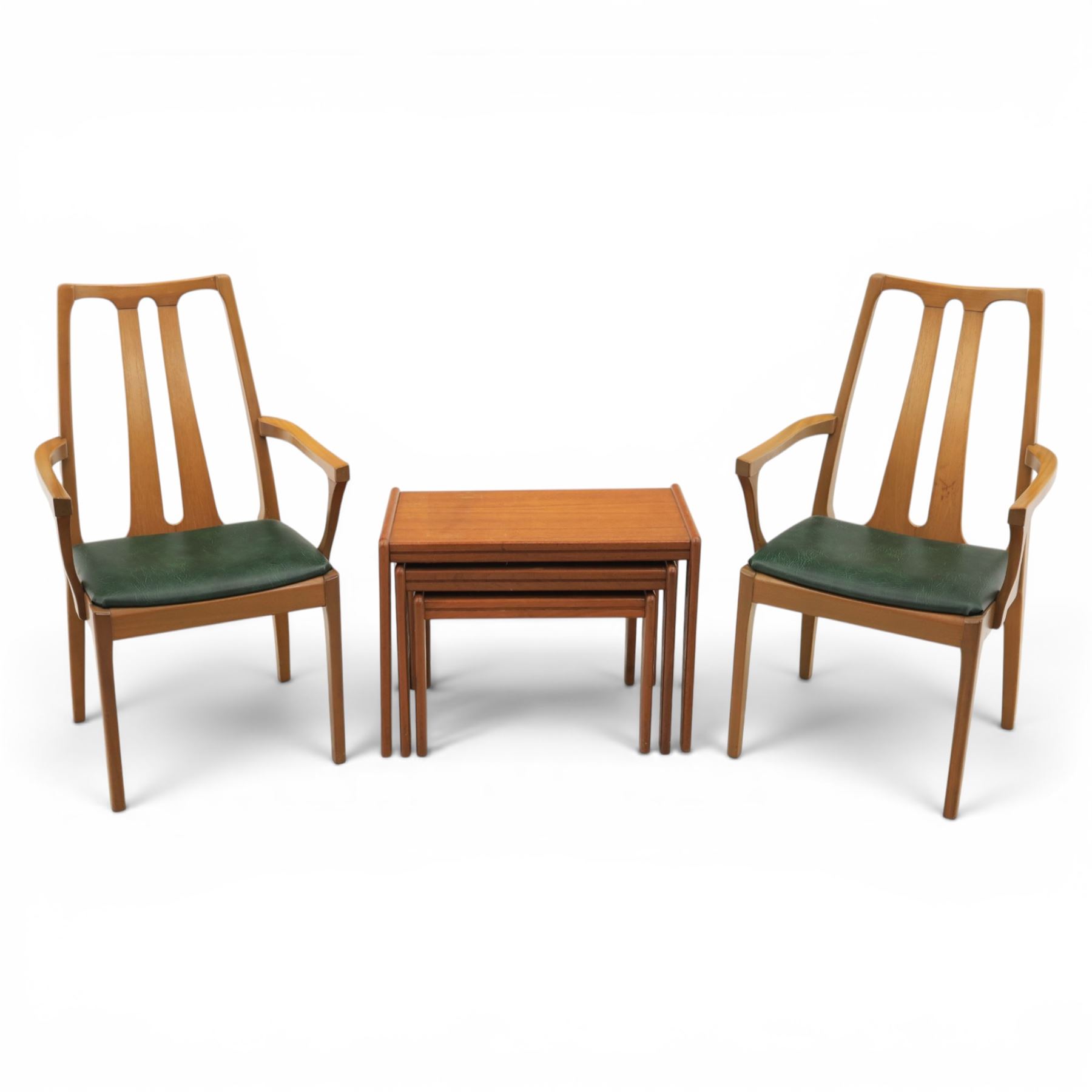 A pair of Nathan 'Highback Carvers' and a 20th century nest of teak tables, (Tables W65cm, D38cm, H49cm)
(Carvers W57, H97)