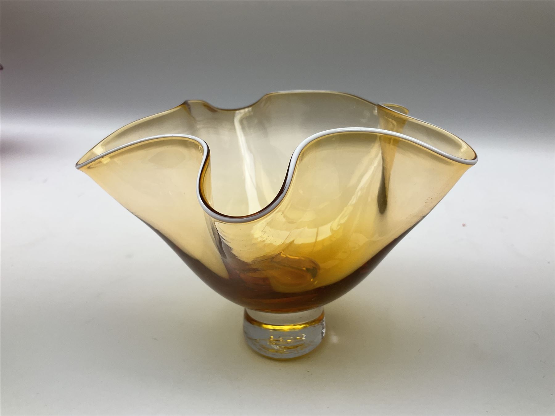 Gillies Jones orange glass bowl with crimped white rim upon a pedestal foot, H11.5cm