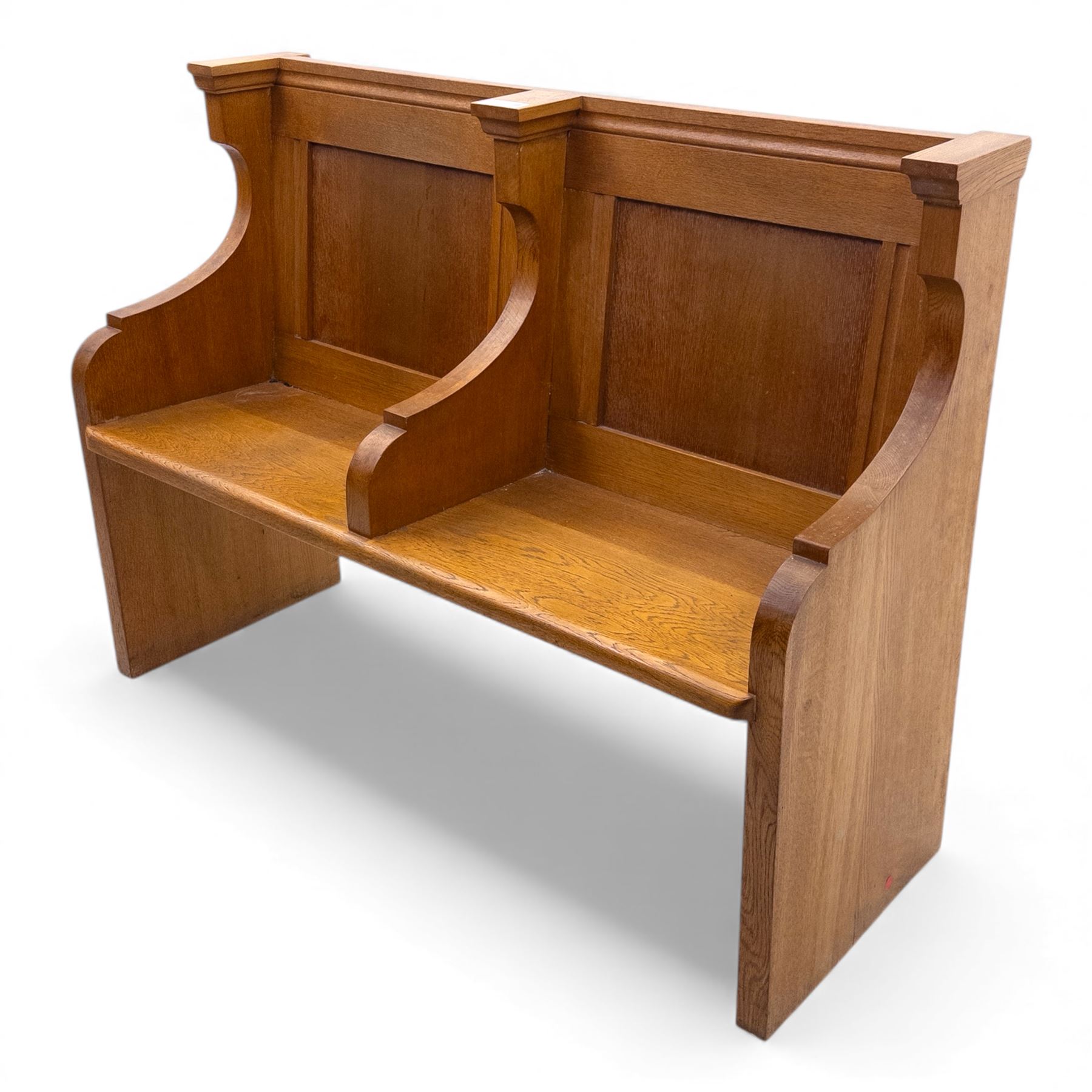 Pair of mid 20th century oak ecclesiastical pews, each with panelled backrests and shaped end supports, of solid construction and mellow honeyed tone