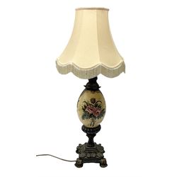Late 19th/early 20th century table lamp, the ovoid  shaped body decorated ornately with painted floral sprays, raised upon footed square base with foliate detail, with tasselled fabric shade, H46.5cm excl fitting