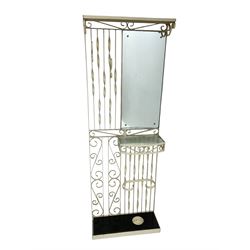 Cream painted scroll work wrought metal hall stand, fitted with mirror, shelf and stick stand