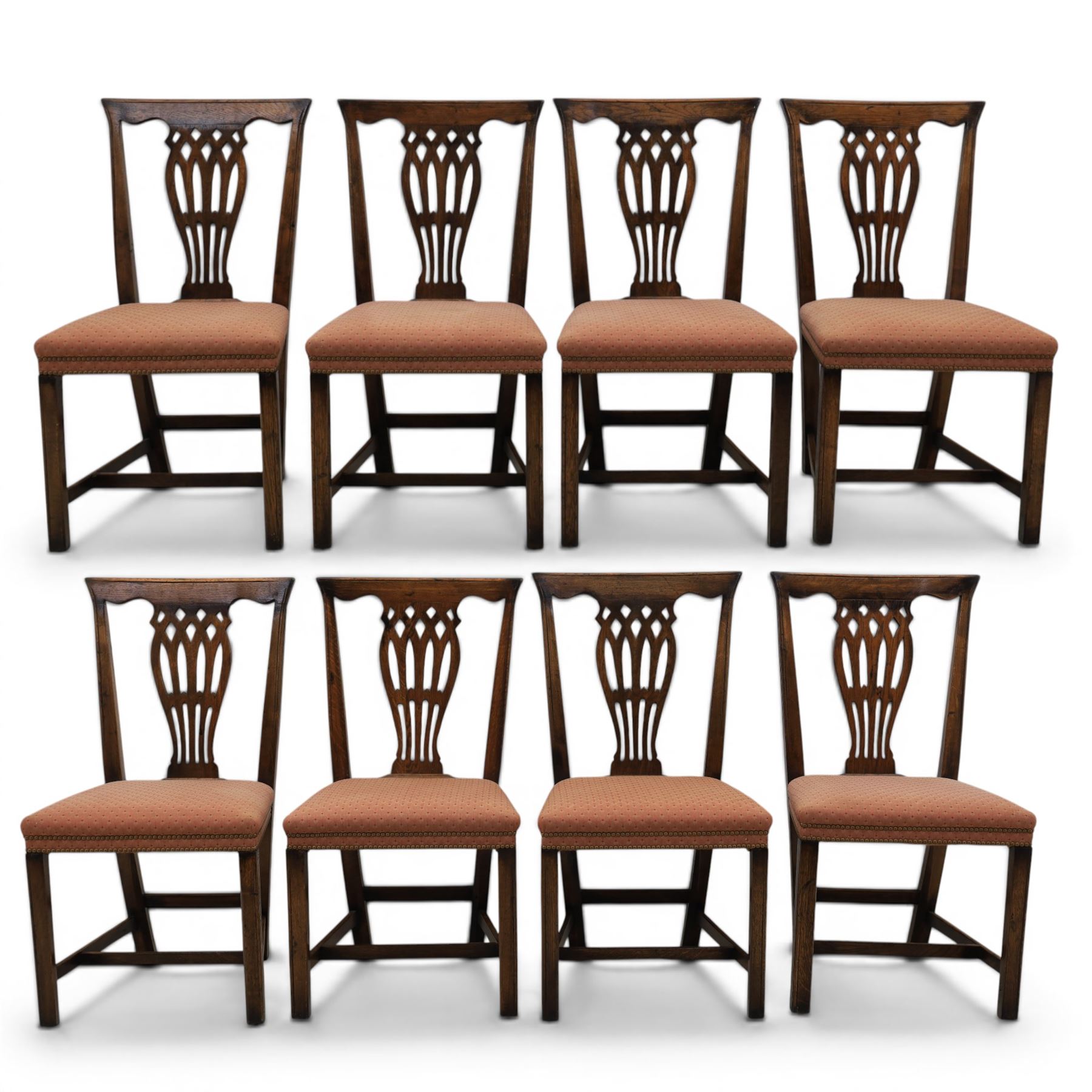 Set of eight George III dining chairs with padded seats, pierced vasiform splat, upholstered seat with brass trim, on square supports with H-stretcher