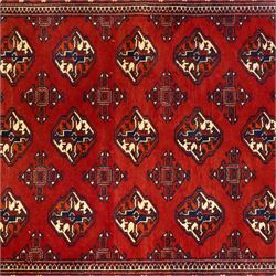 Three rugs,  comprising a Baluch rug in crimson ground, 179x97cm, a Tekke Bokhara rug in crimson ground, 201x132cm, and a Bokhara rug in ochre ground, 125x175cm 