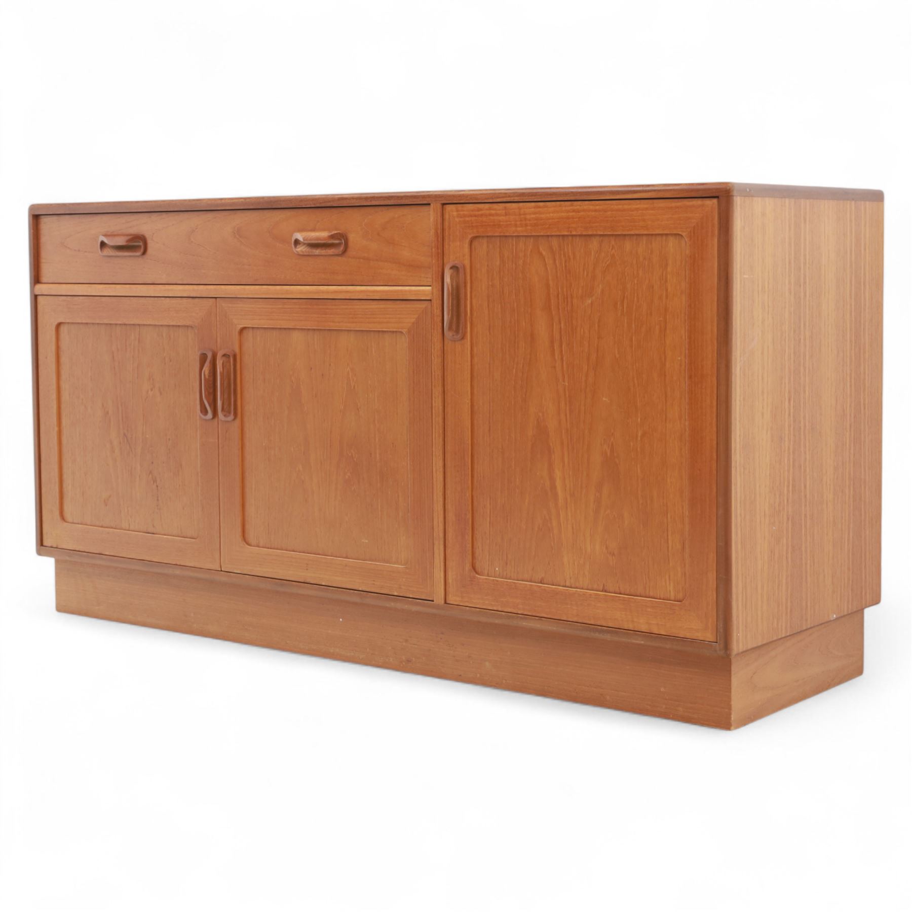 G Plan - Mid-20th century teak sideboard, fitted with single drawer above three cupboard doors, recessed handles throughout, raised on a plinth base