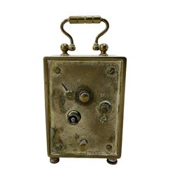 French - petite early 20th century French brass cased travelling alarm clock, with bun feet and carrying handle, circular enamel dial with Arabic numerals and spade hands, conforming alarm setting dial beneath, with a platform escapement, wound and set from the rear.
