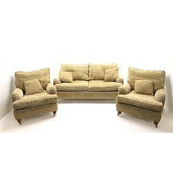 Duresta two seat sofa, upholstered in pale gold fabric, Egyptian pattern, turned supports and brass casters (W172cm, D114cm, H77cm), two matching Duresta armchiars (W84cm, D102cm, H80cm)