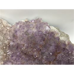 Amethyst crystal geode cluster, with well-defined crystals of various sizes, H13cm, L46cm