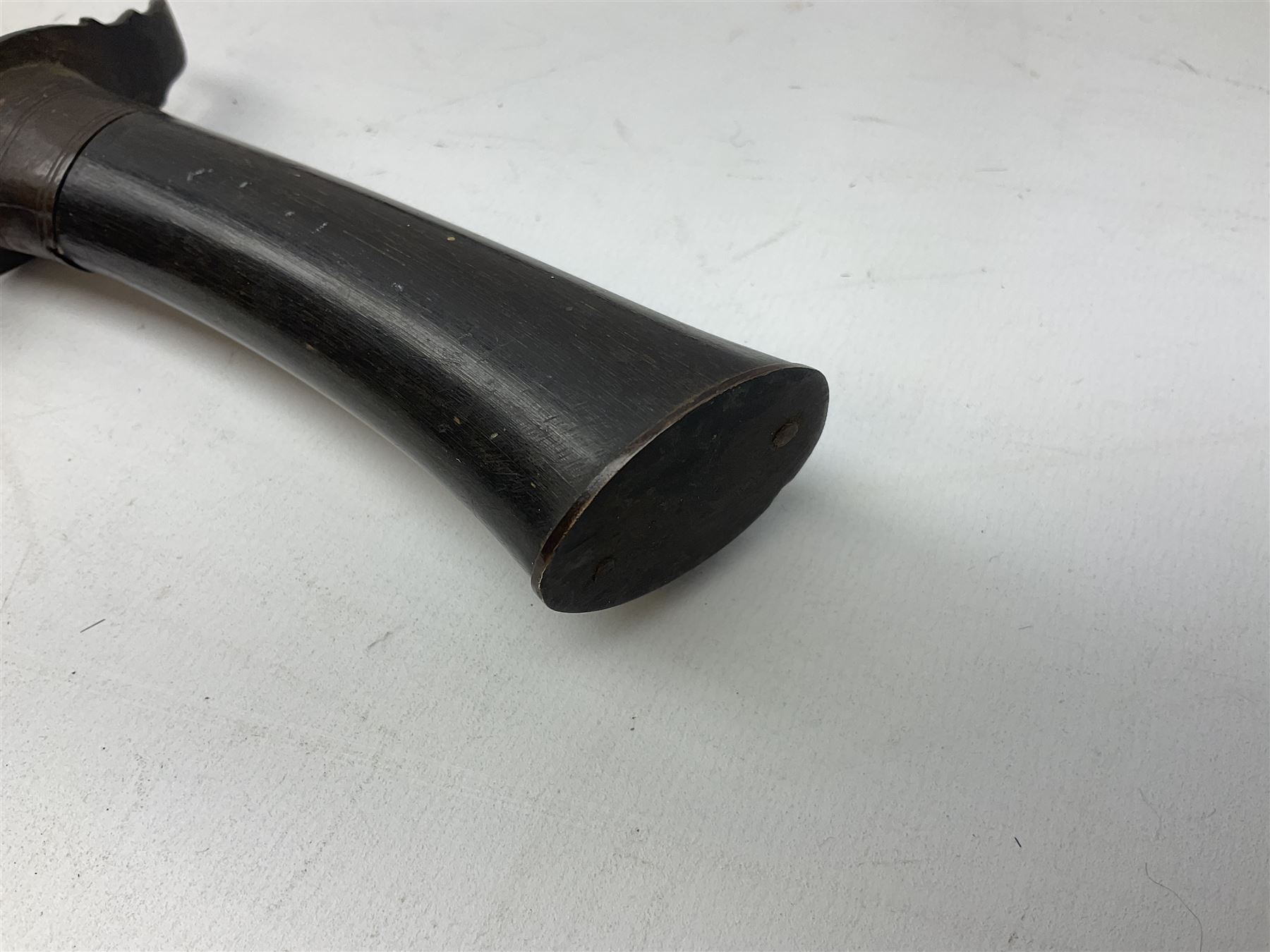 Burmese dha dagger with 15cm steel blade, white metal ferrule and horn handle, in white metal and filigree scabbard L30.5cm; a Burmese long bladed knife with horn handle and brass mounted teak scabbard; and another Eastern dagger in sheath (3)