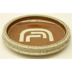  Derek Clarkson (1928-2003): Circular stoneware bowl, the interior decorated with khaki glaze & symbol, impressed monogram, c1980, D20cm   