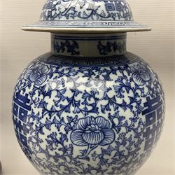 Pair of 20th century Chinese blue and white jars and covers, converted to table lamps, each of baluster form with domed cover, decorated with auspicious symbols, flower heads and training vines, upon turned circular wooden base, including fittings overall H43cm