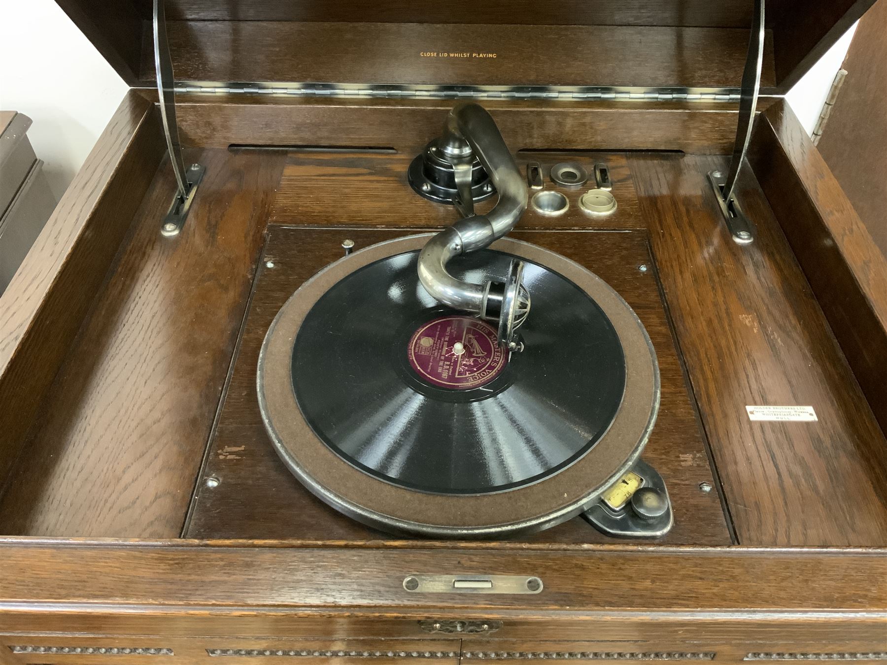 Early 20th century ‘HMV' 202 cabinet gramophone, oak cased, moulded top with foliate carved moulding hinges to reveal gramophone, two doors enclosing horn, on turned supports joined by moulded stretcher rails