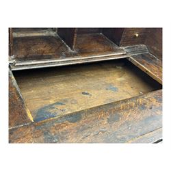 George III oak bureau, sloped fall-front enclosing a fitted interior with pigeonholes, small drawers, and a central compartment, over two short and two long drawers, brass escutcheons and drop handles, raised on bun feet