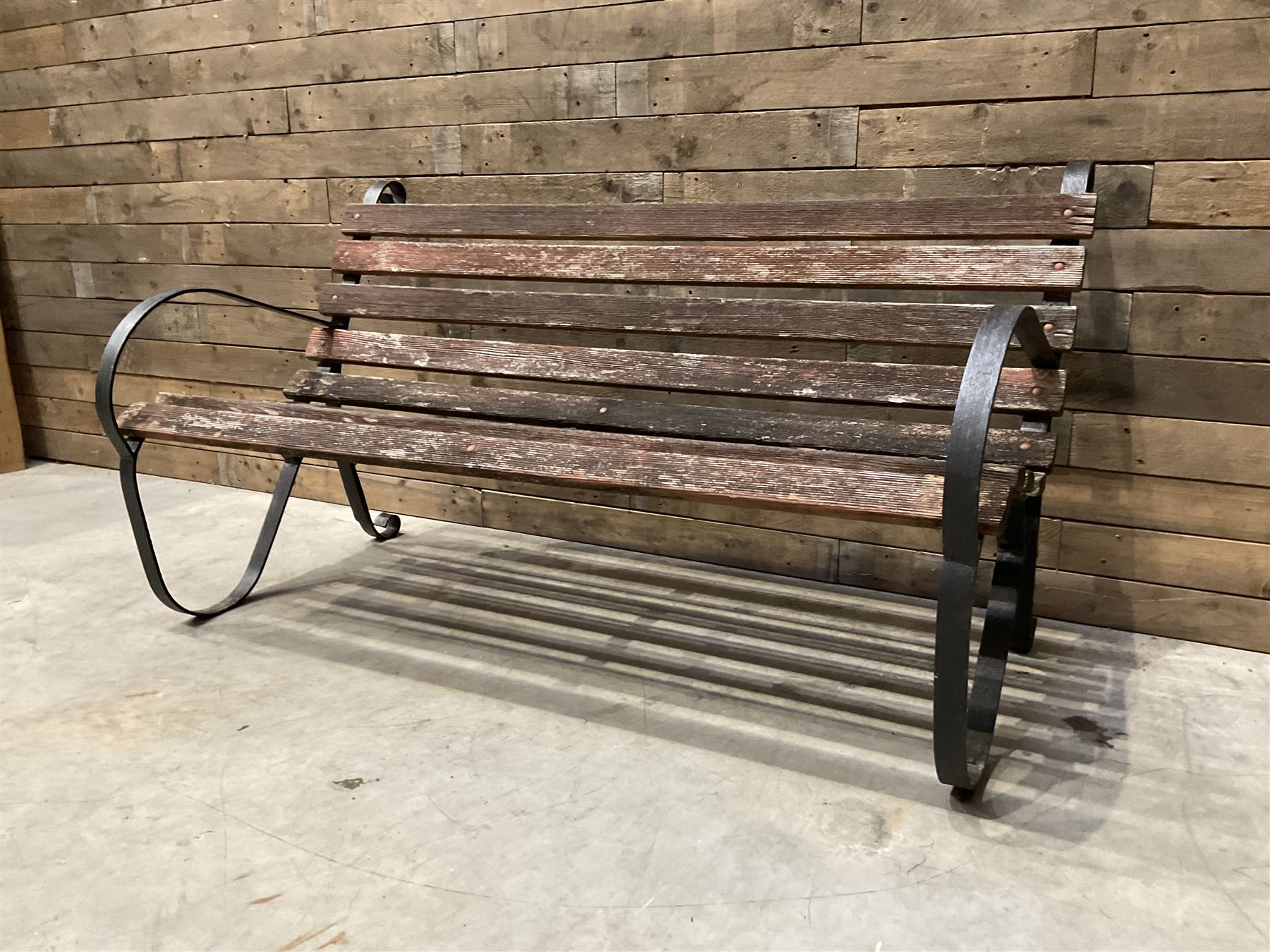 Early 20th century black painted wrought iron and wood slatted garden bench