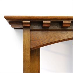 Art Nouveau oak mirrored sideboard, in the manner of Liberty's London, the raised back fitted with bevelled mirror plates divided by turned supports beneath a projecting cornice, above two drawers and panelled cupboard doors, the central panel applied with stylised floral carved panel, raised on shaped feet