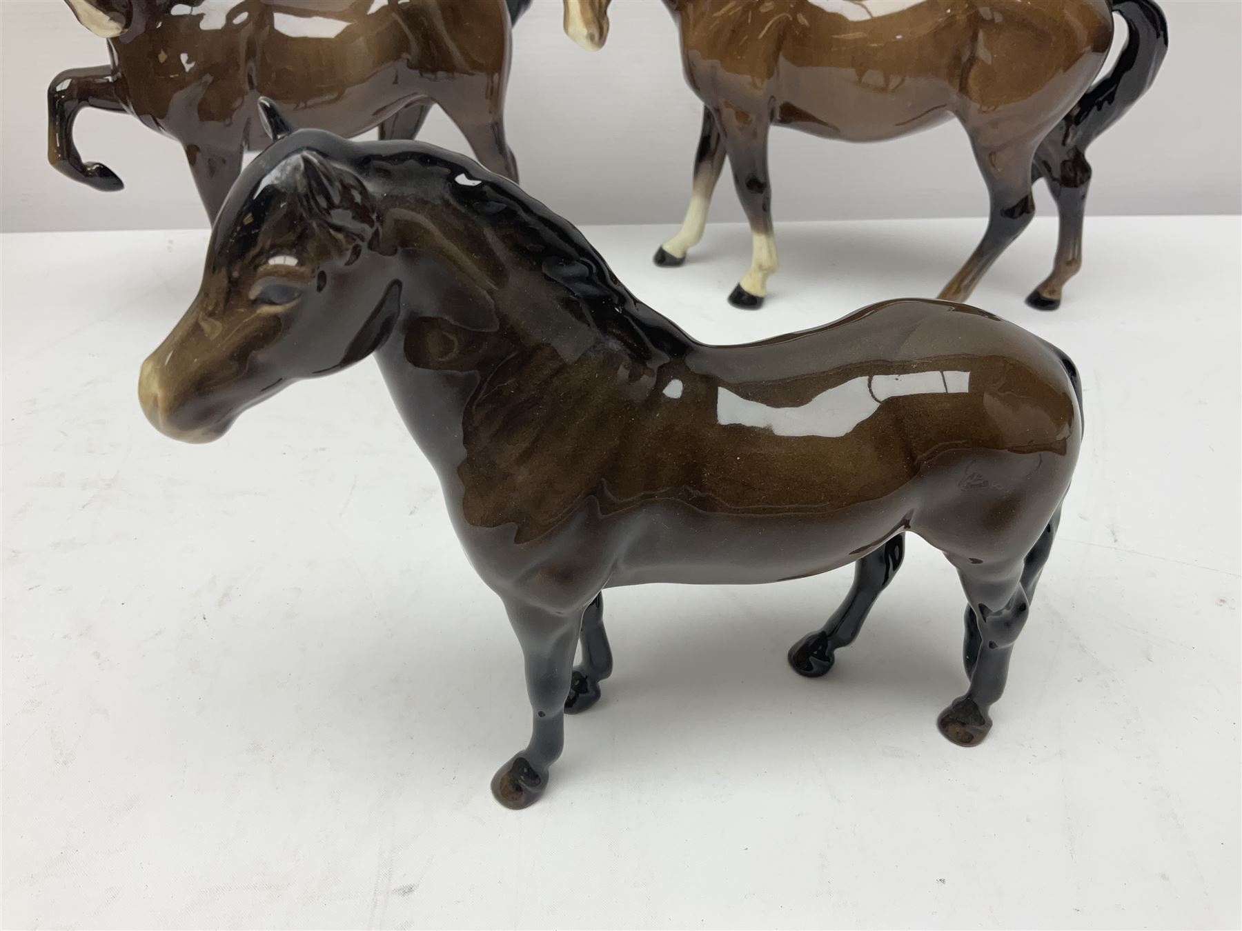 Four Beswick horses, including Exmoor no 1645, Black Beauty foal and two others 