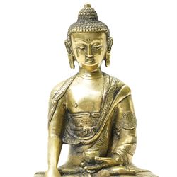 Late 19th/early 20th century brass Buddha in lotus position holding a 'singing' bowl H21cm