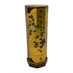 Oriental style gold octagonal lacquered chest, decorated with floral motifs, fitted with four narrow above four deeper drawers 