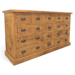 Indigo Furniture - large rustic oak combination chest sideboard, fourteen drawer with blackened metal cup handles, on a plinth base