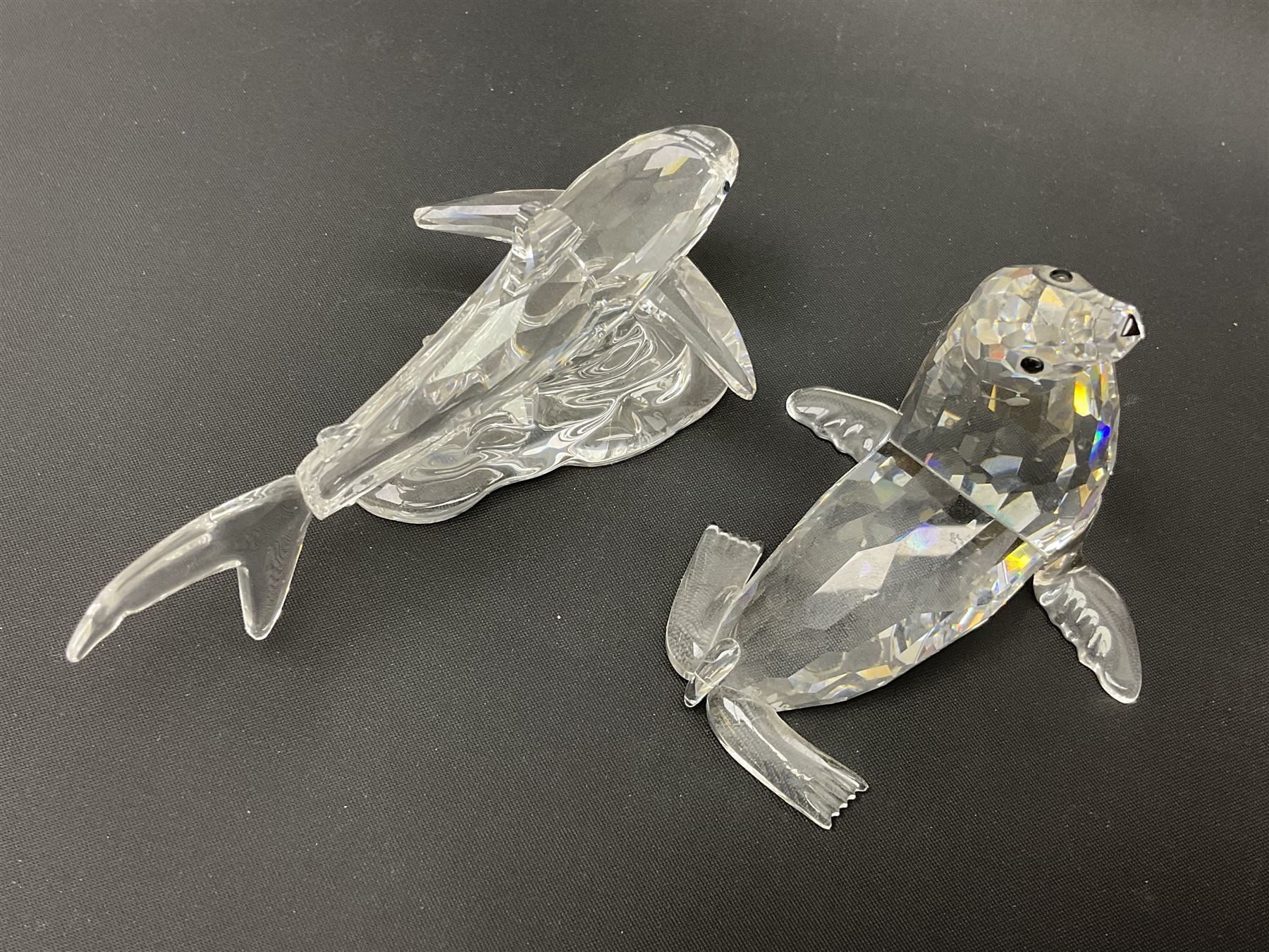 Nineteen Swarovski Crystal sea creatures, to include dolphins, seals, puffer fish, octopus, crabs, together with a quantity Swarovski Crystal shells 