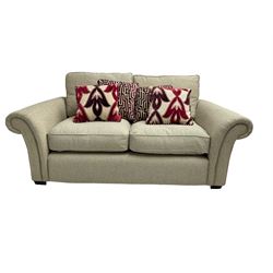 Two seater sofa, upholstered in cream fabric
