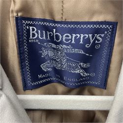 Ladies Burberry double breasted trench coat, with belt and detachable woollen gilet, in traditional cream colour with Burberry check lining, together with a gentlemans Burberry single breasted trench coat, both L112cm