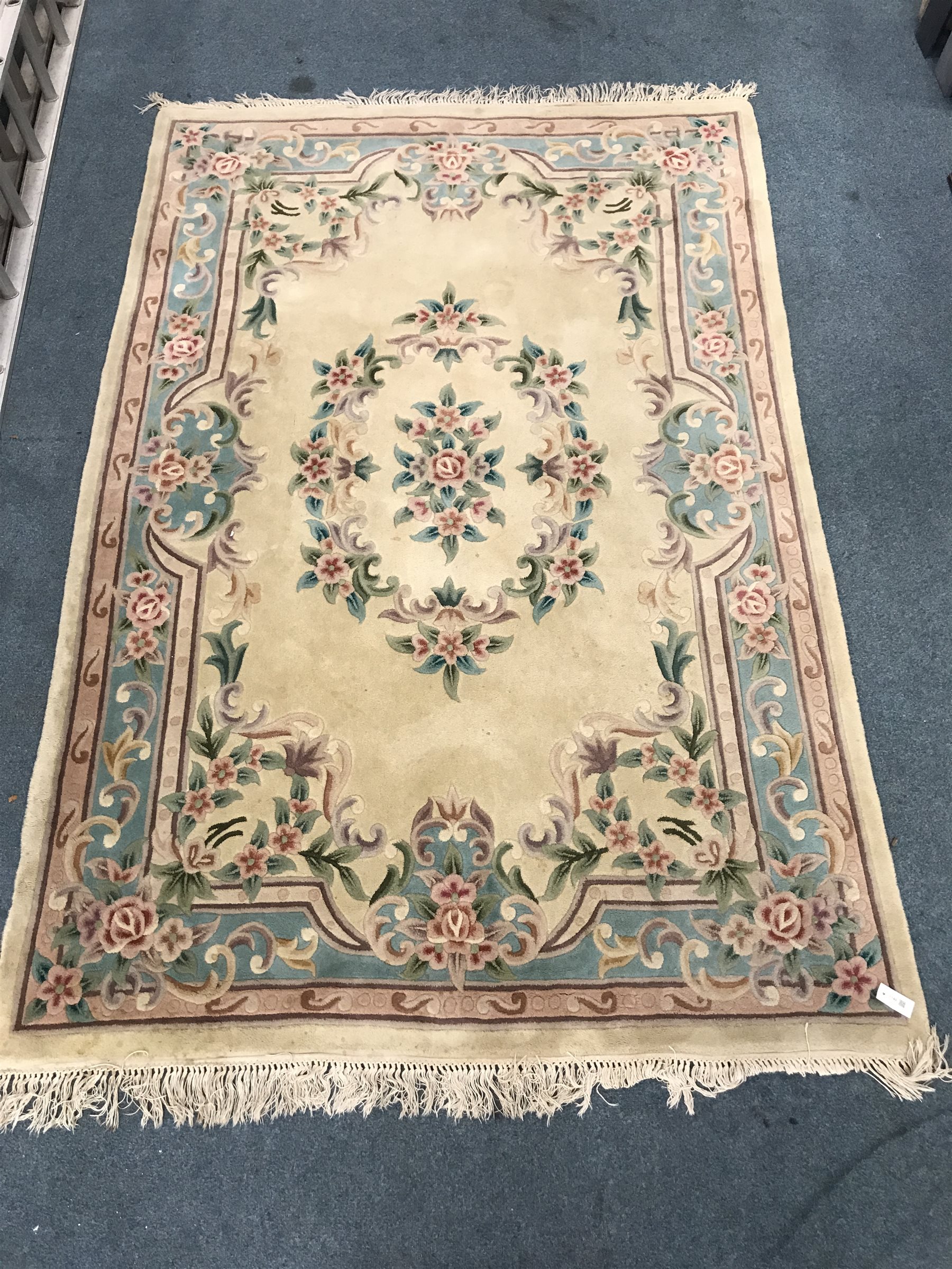 Chinese style beige ground rug, central medallion, repeating border