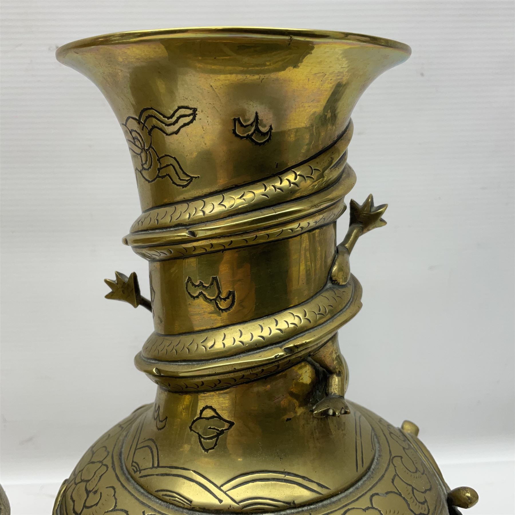 Pair of Chinese brass vases, of ovoid form with elongated neck and fluted rim, decorated in high relief with a dragon chasing a flaming pearl around the neck, the body with dragons, birds and buildings, with character marks beneath, H25cm