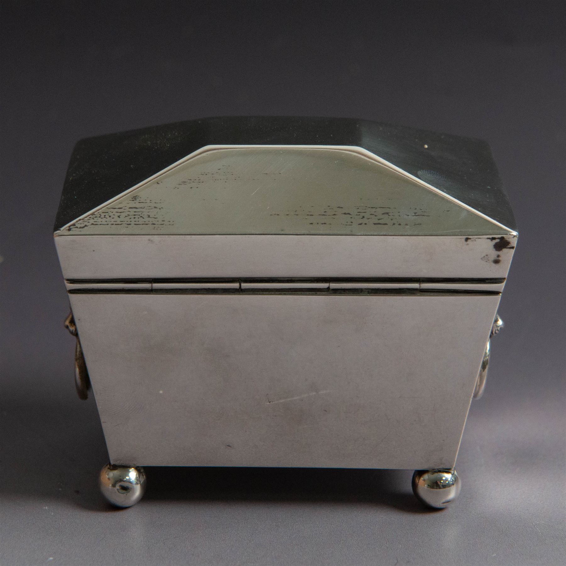 Early 20th century silver tea caddy, of sarcophagus form with twin lion mask mounted loop handles, upon four bun feet, hallmarked William Hutton & Sons Ltd, Birmingham 1913, H8cm, W9cm