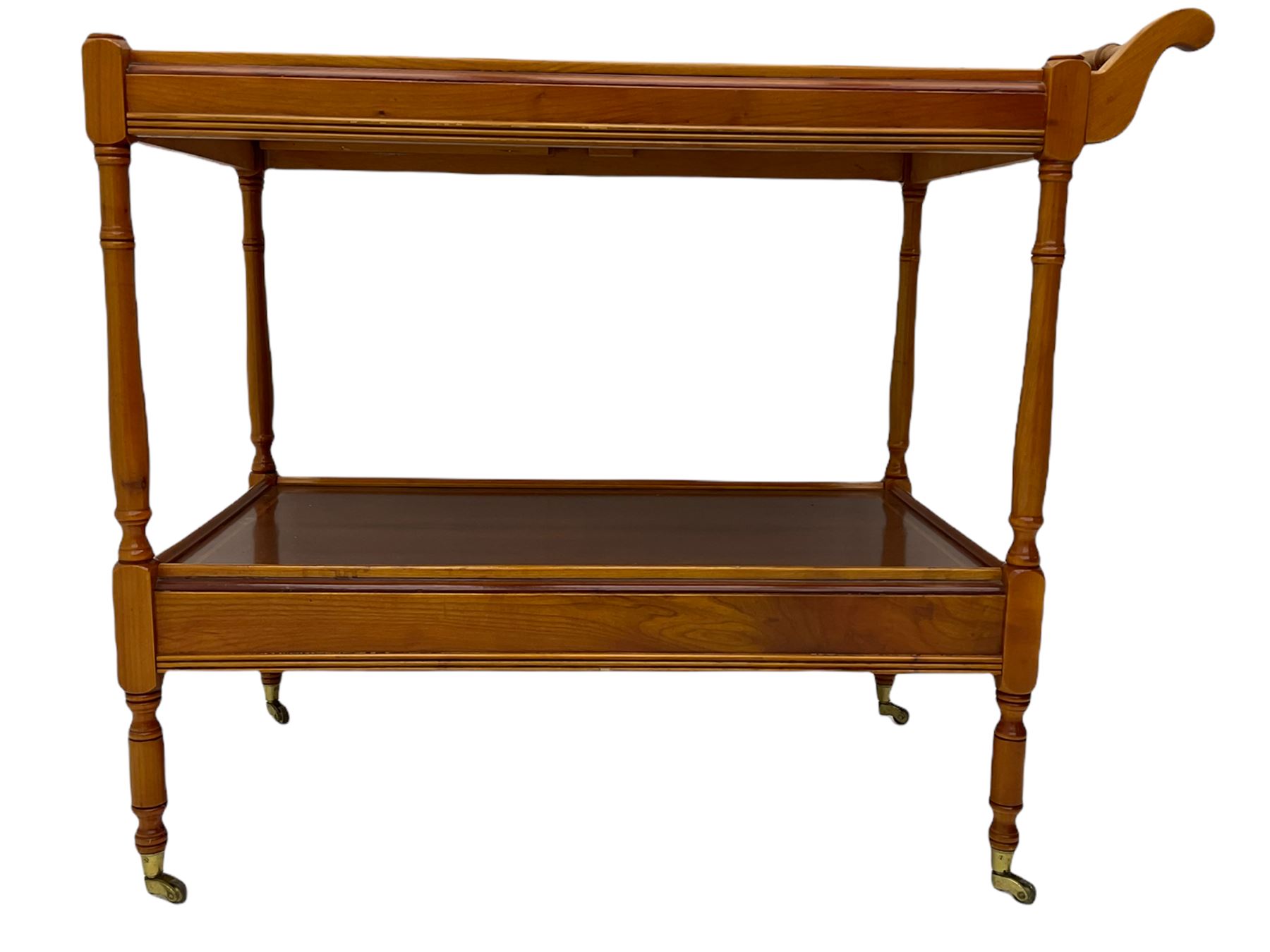 Yew wood drinks trolley, rectangular form with leather inset slide and turned handle, the undertier fitted with drawer, turned supports and brass castors