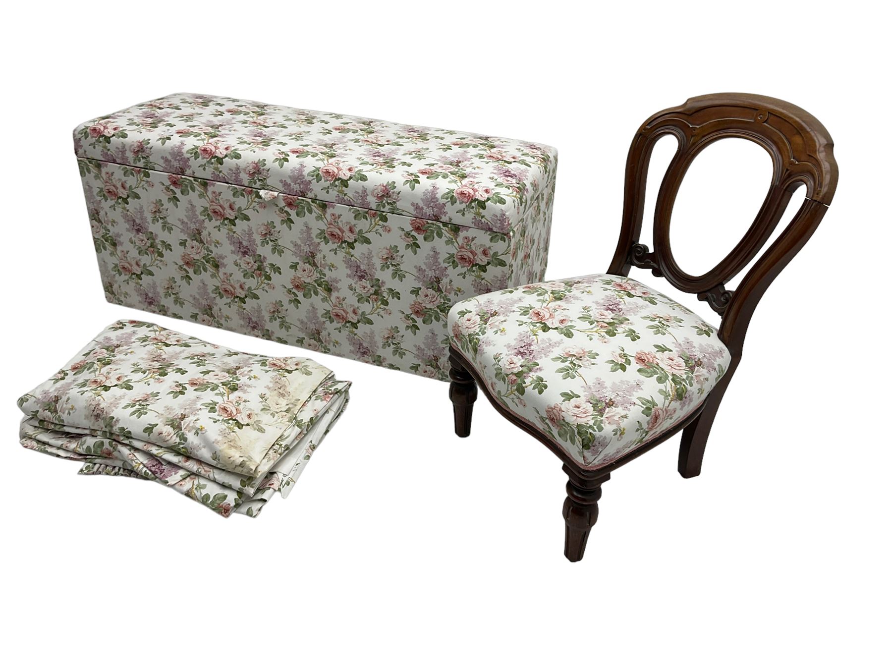 Ottoman blanket box upholstered in floral pattern fabric, matching bedroom chair and curtains