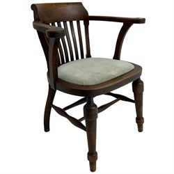 Early 20th century oak smoker's bow armchair, tub-shaped back with scrolled arm terminals, upholstered seat, on turned front supports united by swell-turned stretchers 