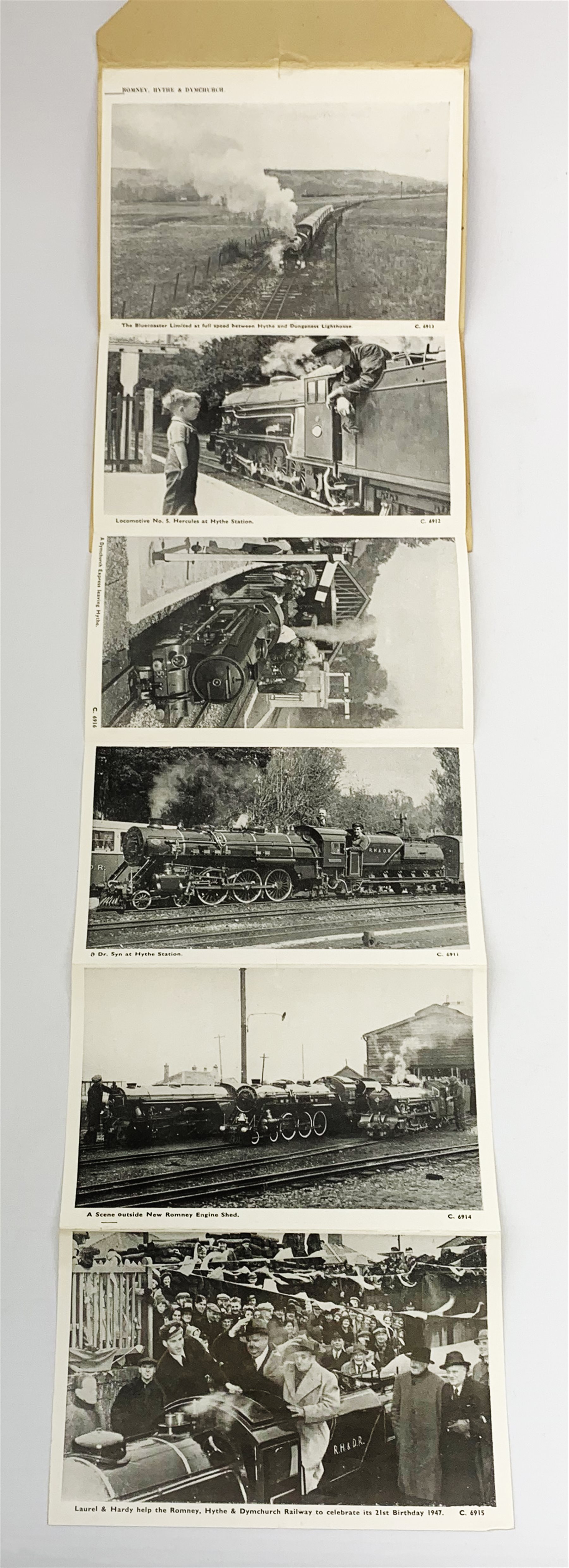 Walt Disney (1901-1966), American Animator, Academy Award Winner, signed letter card in blue ink, the envelope folding out to reveal six views in black and white of Romney, Hythe and Dymchurch Railway, and hand written letter detailed 'This afternoon we were talking to Walt Disney down at Dungeness, that's his autograph on the back of the card, he was driving one of the miniature trains.', post marked indistinct, dated 52. 