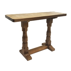  'Mouseman' hand adazed oak twin pedestal alter table, two carved hexagonal supports joined by single floor stretcher by Robert Thompson of Kilburn, W107cm, H73cm, D38cm  