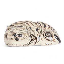 19th century Chinese Cuzhou style glazed pottery model of a cat, modelled in a lying position, and decorated with brown markings upon a cream ground, with opening to back and both ears possibly for incense, H8.5cm L23cm