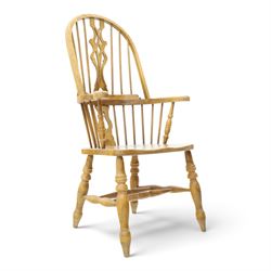 Traditional elm Windsor armchair, hooped spindle back with pierced splat, shaped elm seat, on turned supports united by double H stretcher, turned supports